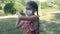 Beautiful little girl plays badminton in a medical mask. Virus protection.