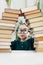 Beautiful little girl portrait in glasses with books