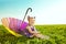 Beautiful little girl with rainbow umbrella on the grass in the