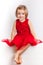 Beautiful little girl in red dresses