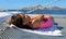 Beautiful little girl relaxing in sailboat while listening to music on the ocean