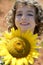 Beautiful little girl in a summer sunflower field