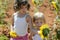 Beautiful little girl in a summer sunflower field