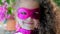 Beautiful little girl in the superhero costume, close up portrait child in the mask of the hero.