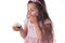 Beautiful little girl surprised from a tasty big chocolate coconut candy as a ball. Kid ready to eat cake