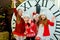 Beautiful little girls with a big clock