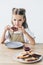 beautiful little schoolgirl eating toast with jam