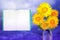 Beautiful live daisy or chamomile bouquet bouquet in glass vase with notepad with place for your text on left on colored sky with