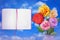 Beautiful live rose bouquet bouquet in porcelain vase with opened note book with blank place for your information on left on cloud