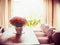 Beautiful living room with Chrysanthemums flowers bunch on dinner table at window background.