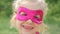 Beautiful llittle girl in the superhero costume, close up portrait child in the mask of the hero.