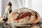 Beautiful loaves of bread on a leaven of white wheat on a plate on the edge of the canvas. Homemade cakes, handmade. Close up