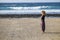 Beautiful lonely caucasian middle age woman walk and enjoy the nobody beach in season. freedom and alternative lifestyle concept