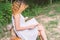 Beautiful lonely woman sitting reading on the bench.