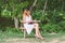 Beautiful lonely woman sitting reading on the bench.