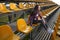 Beautiful lonely woman sitting on tribunes and laughs