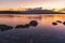 Beautiful long exposhure sunset landscape . The small lake with stones in the water, beautiful panorramic viwe on the mountais aft