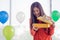 Beautiful long-haired Asian woman wearing a red sweater is excited when opening a yellow gift box.She was surprised with the New