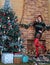 Beautiful long legged redhead girl in red stockings and heels  posing in Christmas decoration