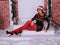 Beautiful long legged redhead girl in red stockings and heels  posing in Christmas decoration