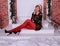 Beautiful long legged redhead girl in red stockings and heels  posing in Christmas decoration