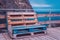 Beautiful look out on the ocean with pellet seats. Wooden bench made of pallets of freight cargo cases for sitting. Creative