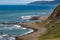 Beautiful Lost Coast beach and hills in shadow extend invitation to visit to viewer