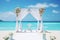 Beautiful lovely ceremony decoration of a beach wedding with blue sea background. Summer tropical vacation concept.