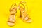 Beautiful luxurious vintage evening elegant women's sandals with rhinestones, high heels, on a yellow background