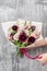 Beautiful luxury bouquet of mixed flowers in woman hand. the work of the florist at a flower shop