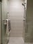 Beautiful luxury shower box decoration in bathroom interior, with tower hanging on towel rack in bathroom door