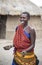 Beautiful maasai woman with cow dung on her hands that she used to build her house