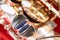 Beautiful macro photo of the details of a wind instrument of a golden alto saxophone on a red background