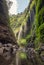 Beautiful Madakaripura waterfall flowing in rocky valley