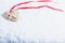 Beautiful magical vintage beige heart tied with a red ribbon on a white snow background. Winter and Christmas concept