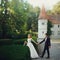 Beautiful magical young bride holding hands handsome groom castle background