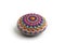 Beautiful mandala hand painted on a sea stone, isolated