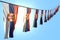 Beautiful many Serbia flags or banners hanging diagonal on rope on blue sky background with soft focus - any occasion flag 3d