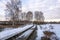 Beautiful March landscape with birches and a railroad leaving into the distance