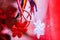 Beautiful Martisor with Romanian tricolor elements on red holiday background. Martisor is a red and white string which is offered