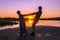 Beautiful mature couples dance on a wild beach in the rays of the setting sun