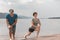 Beautiful mature sportive couple doing gymnastic exercises on the beach