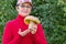 Beautiful mature woman holding in her hands a big white mushroom freshly plucked