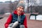 Beautiful Mature Woman Pouring Hot Tea From Thermos In Park After Active Fitness Training With Friends.