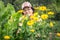 Beautiful mature woman of retirement age among daisies in the garden