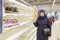 Beautiful mature women are surprised at the empty shelves in the supermarket after rush demand during the epidemic. Text in Russi