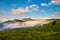 Beautiful meadows in mountains are covered by clouds