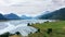 Beautiful meadows and river surrounded by mountains in Fiordland National Park near Glenorchy