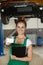 Beautiful mechanic girl shows her business card