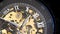 Beautiful mechanical gold watch with open gears and mechanism.The dial of a vintage watch with Roman numerals,watch the time and t